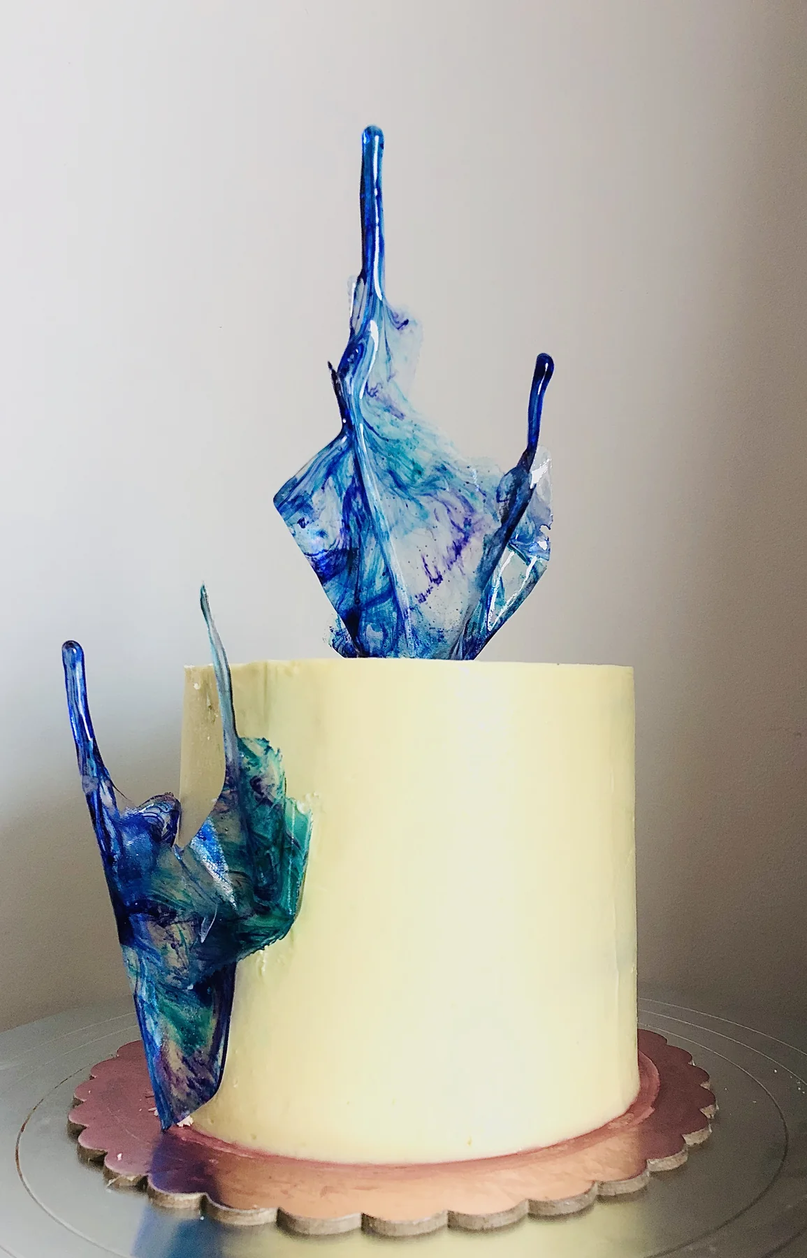 Cream-frosted cake with translucent blue blown-sugar shards