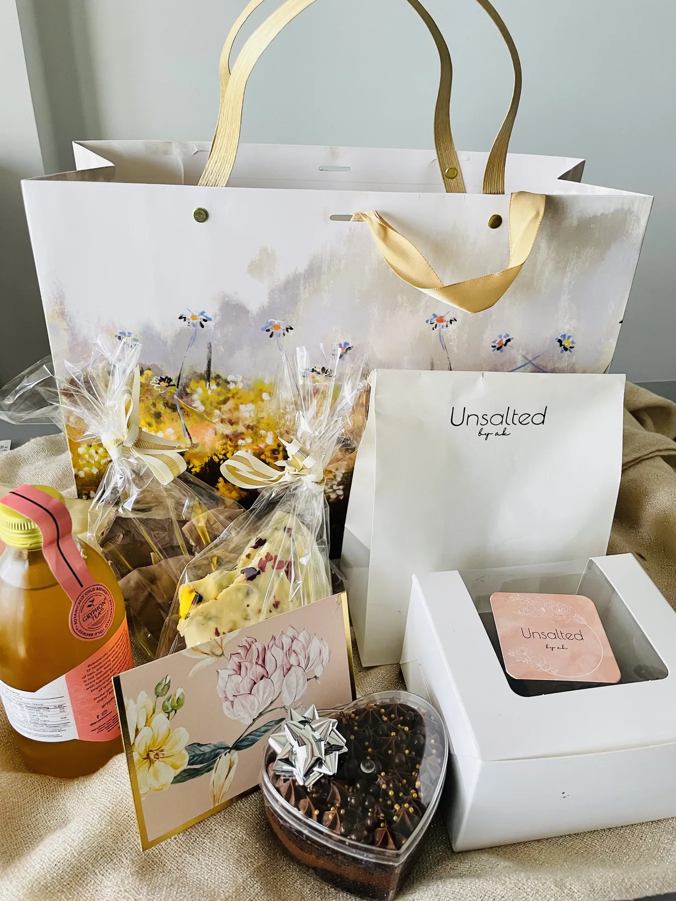 Styled gifting table with curated products, ribbons and seasonal foliage