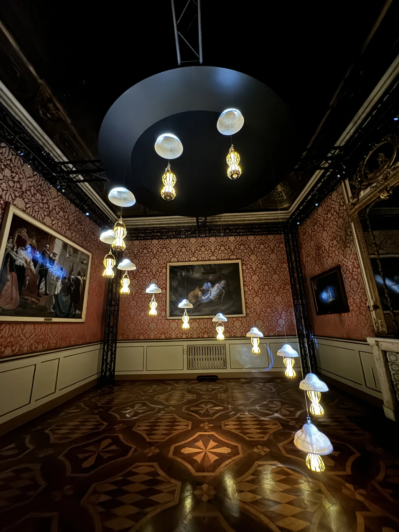 Baroque gallery room with floating jellyfish-like light installations