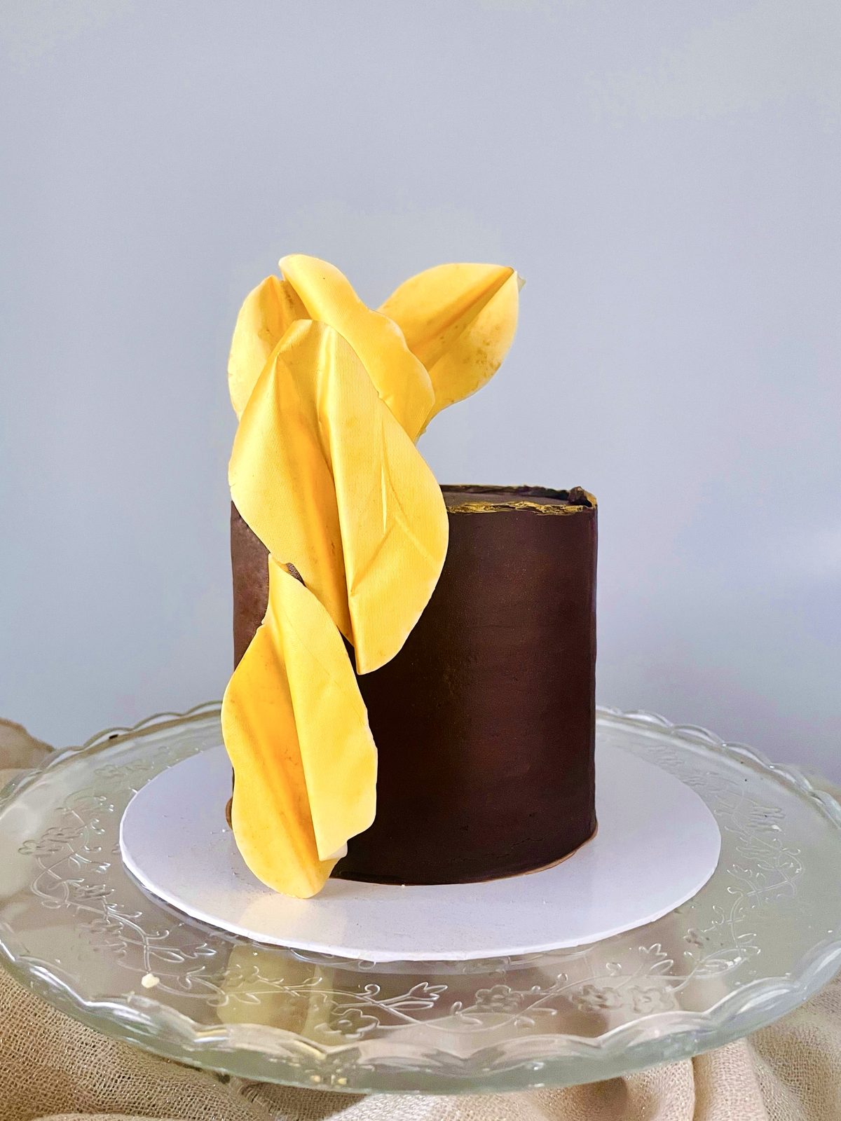 Chocolate cake with a sculpted yellow drape