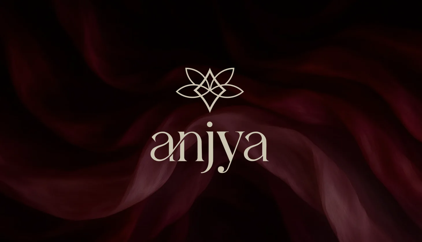 Gold botanical mark and serif wordmark on dark silk